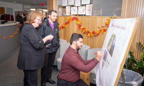 people sign a poster to adopt the Okanagan Charter