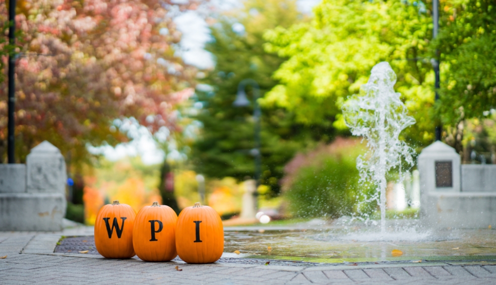 3 pumpkins with W, P, and I painted on them placed next to each other on campus view