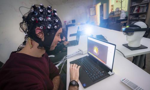 WPI student wearing a specialized cap with sensors to measure brain waves.
