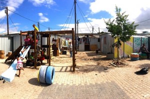 Children using the playground under construction at the Flamingo Crescent settlement.