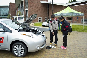 Visitors check out the charging system on the Nissan Leaf during last year’s show.