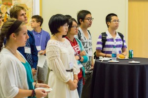 Huilin Yang, center, one of six Charles O. Thompson essay finalists, listens to remarks during the recognition program.