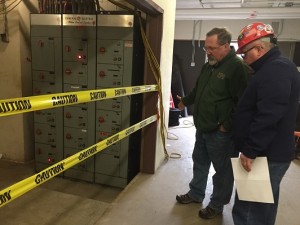Chris Salter of the Facilities Department consults with a member of Consigli Construction’s crew.