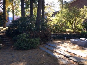 A stone staircase leads through shrubbery to the Adam El-Khishin Meditation Area, a quiet space featuring a reflecting pool with a gently bubbling fountain at its center.