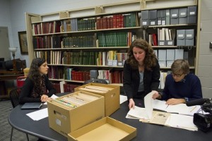 Producer Julia Montfort and journalist Guy Lagache of Paris-based production company Let’s Pix speak with Jess Colati (center) at the Gordon Library about WPI’s extensive Robert J. Harvey collection.