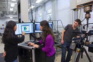 Lados (center), Spangenberger, and PhD candidate Yuwei Zhai set up a test of an aircraft aluminum alloy