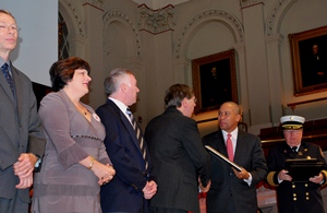 From left, John Orr, Kathy Notarianni, James Duckworth and David Cyganski accept the Fire Marshal’s Award from Governor Patrick.