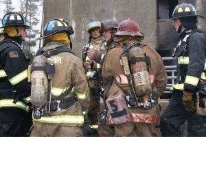 Firefighters at the Massachusetts Firefighting Academy prepare for a test of a toxic gas detection system (inside the red box) developed at WPI.